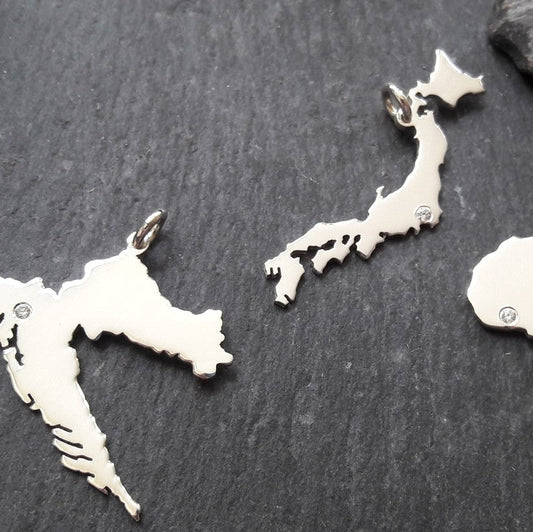 Personalisierung unserer Landkartenanhänger mit einem Zirkonia (ca. Ø 1,3 mm)